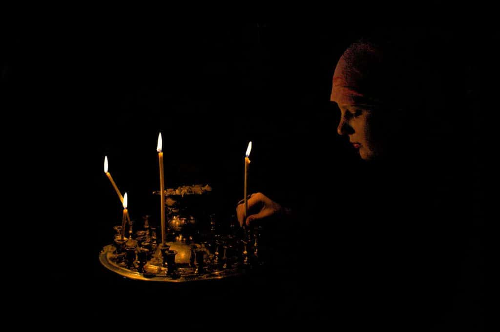 lighting candles in Kyiv cathedral