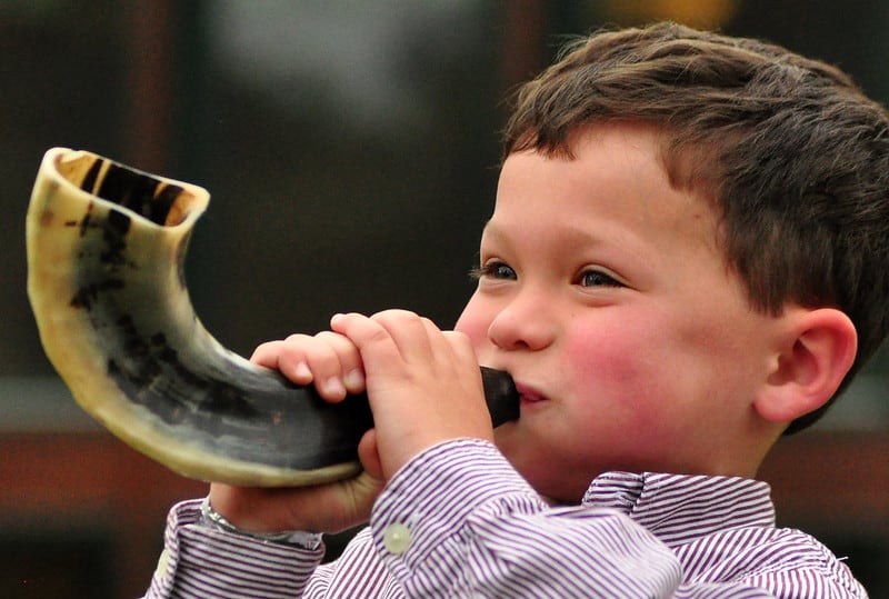 Boy blowing shofar for Jewish new year