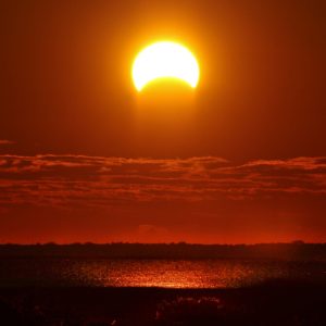 eclipse 4-8-24_partial_eclipse_over_water_sacketsharbor_creativecommons_RawPixel-1200x675